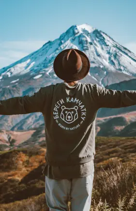 a person standing on front of a snowy mountain